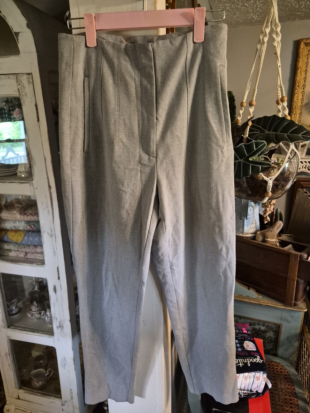 grey tailored trousers resemble Zara high-rise pleated pants.